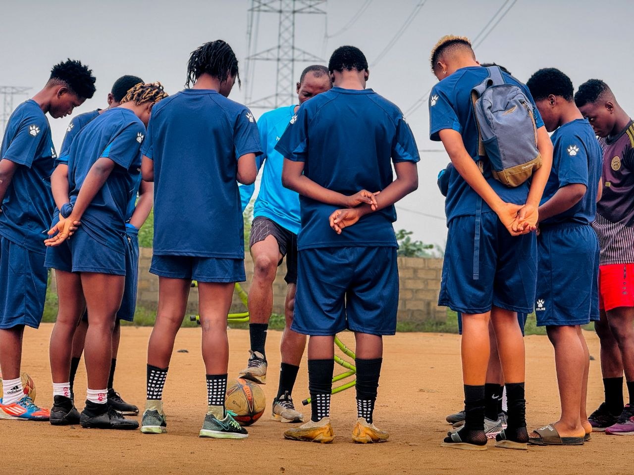 BlueWhale players in a team huddle on the pitch — the future being built together